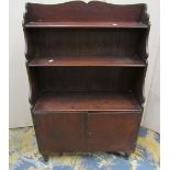 A small Regency mahogany waterfall bookcase fitted with three shelves of graduated depth, two simple