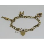 Modern 9ct curb link charm bracelet with heart padlock clasp, hung with three novelty charms
