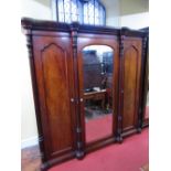 Good quality Victorian breakfront triple wardrobe, the central mirror panelled door enclosing a