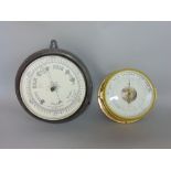 Two wall barometers the better in a brass bulk head type case with open movement, 17 and 24 cm