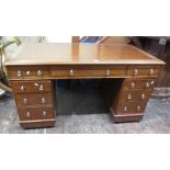 A Victorian mahogany pedestal writing desk fitted with nine frieze drawers with inset top, 140 cm