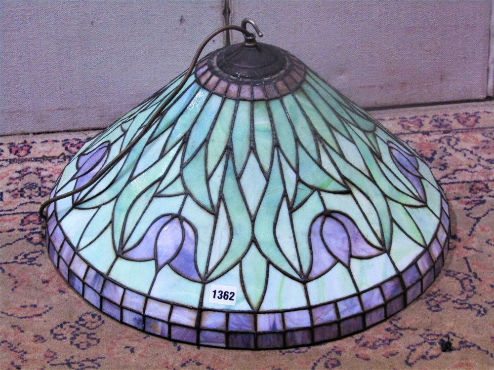 A Tiffany style leaded light hanging ceiling light with domed shade and repeating foliate detail, 50