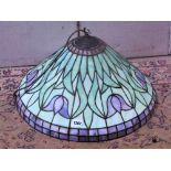 A Tiffany style leaded light hanging ceiling light with domed shade and repeating foliate detail, 50