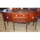 A Regency mahogany sideboard with inlaid ebony stringing, the shallow breakfront fitted with a
