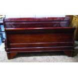 A reproduction hardwood sleigh bed with panelled and scrolled head and foot boards, compete with