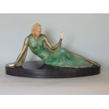 Art deco figural study of a recumbent lady holding a flower, with possible ivory head and hands,