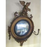 A Regency period convex mirror, 29 cm mirror within a reeded slip and moulded frame supporting two
