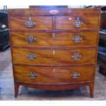 A Regency mahogany bow fronted chest of three long and two short drawers with caddy top and raised