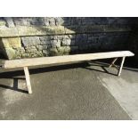 An oak bench or form, the seat raised on four square cut supports with exposed mortice joints, 205
