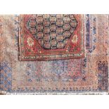 Saraband rug with traditional medallion decoration upon a navy blue ground, 145 x 110cm; together