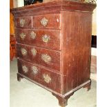 A Georgian oak bedroom chest of two short over three long graduated drawers, with brass swan neck