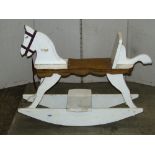 A rustic vintage child's wooden rocking horse with painted finish