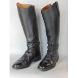 A pair of black leather riding boots in good condition by Soubirac UK size 4.5, in associated boot