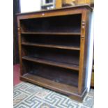 A Victorian oak freestanding open bookcase with three adjustable shelves flanked by simple split