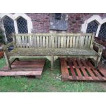 A good quality weathered teak park or garden bench with slatted seat and back, 241cm long