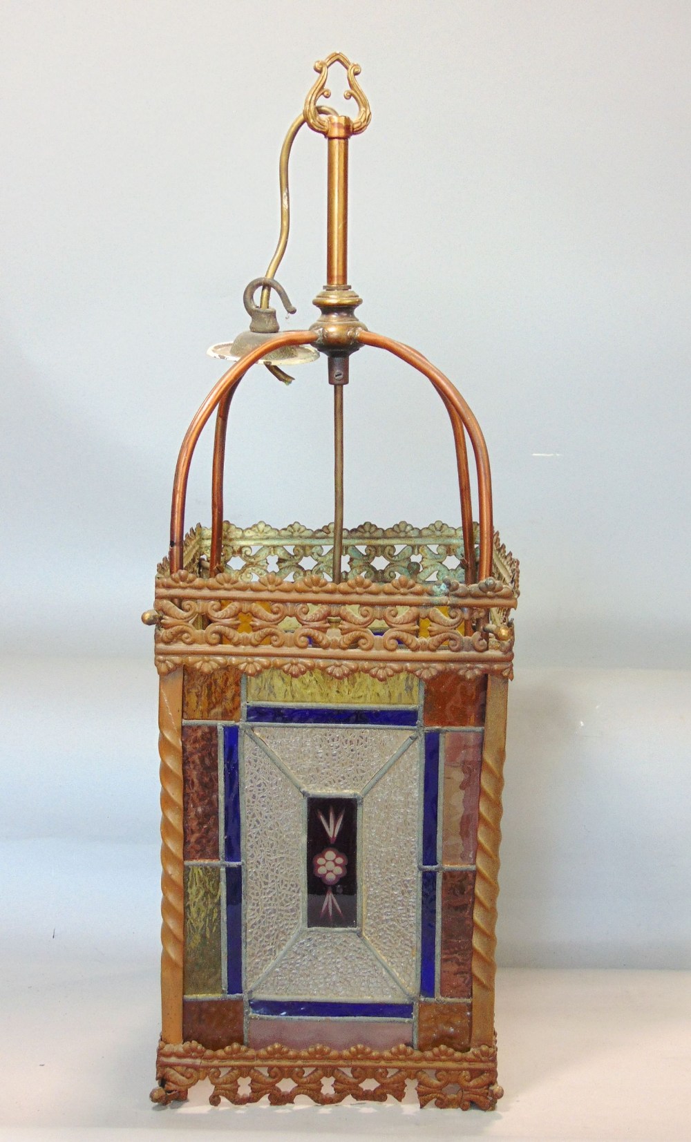 A Victorian brass framed hall lantern, with pierced borders and enclosing geometric leaded light