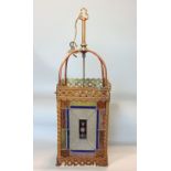 A Victorian brass framed hall lantern, with pierced borders and enclosing geometric leaded light