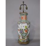 A large oriental lamp base of lobed form with polychrome painted decoration incorporating flowers,