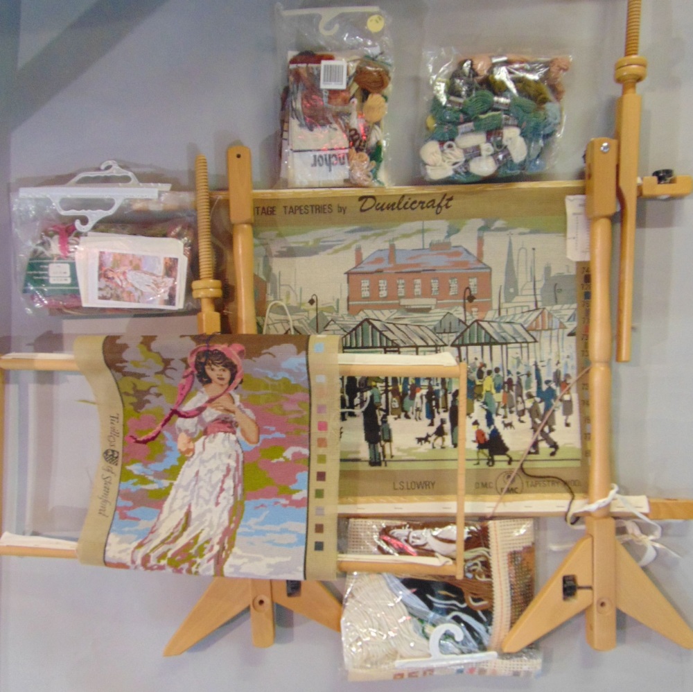Wooden needlepoint/ tapestry frame, with a part worked Lowry tapestry canvas and