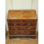 An 18th century walnut writing bureau, the front elevation enclosed by two long and two short