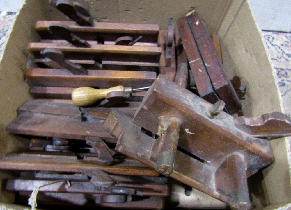 21 vintage wooden carpentry moulding planes, and a sharpening stone