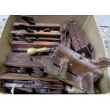 21 vintage wooden carpentry moulding planes, and a sharpening stone
