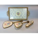 A Bohemian filigree work brass dressing set comprising two brushes, mirror and tray fitted with lace
