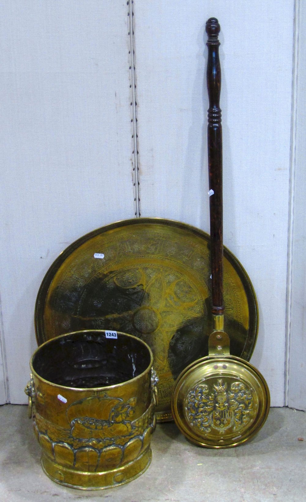 An arts and crafts style polished brass coal bucket, with lions mask and ring handles and galleon