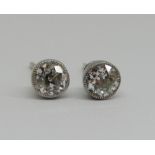 Pair of diamond solitaire stud earrings, 0.25cts each approx, millegrain set in unmarked white