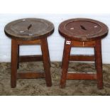 A pair of contemporary low oak pub stools, with circular moulded pierced seats, raised on slightly