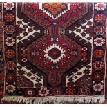 Good quality full pile Heriz runner, with various colourful medallions upon a red ground, 325 x