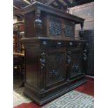 A 19th century carved oak side cupboard, enclosed by a pair of rectangular panelled doors, with