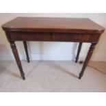 A mid 19th century mahogany D end fold-over top tea table, raised on four turned supports, 88cm wide