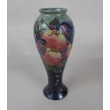 A Moorcroft vase of slender shouldered form in the Finch and Fruit pattern with impressed marks