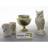 A Belleek vase in the form of an owl, a pair of Belleek mugs with basket weave and Shamrock