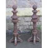 A pair of unusual cast iron fire dogs with sphere and faceted finials 60 cm in height approx