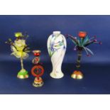Two unusual flamboyant colourful glass and resin candle holders of flower shaped form, both raised