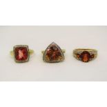 Three 9ct red gem stone dress rings set with diamonds; a flourite, quartz and topaz example, 11.6g