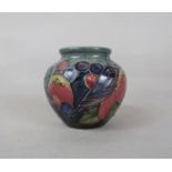 A Moorcroft low vase in the Finch and Fruit pattern with impressed marks to base, 7.5cm tall approx