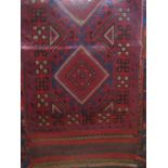 An Eastern wool runner principally in a red and blue colourway with multi-medallion centre within