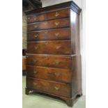 A Georgian oak chest on chest fitted with an arrangement of six long and two short graduated drawers