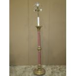 Gilt wood standard lamp with foliate detail, the stem partially upholstered and raised on a disc