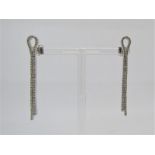 Pair of 18ct white gold diamond set earrings of articulated ribbon form, 8.1g total
