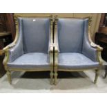 A pair of antique Louis XI style winged armchairs