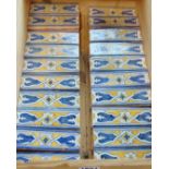 A quantity of hand painted terracotta frieze tiles with repeating detail, each piece 14cm x 4.5cm,