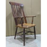 A Windsor stained elm and beechwood lathe back armchair raised on turned supports and stretchers