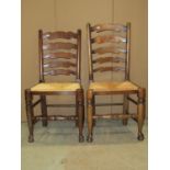 A set of eight good quality reproduction ladderback cottage chairs with rush seats on pad feet