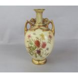 A Royal Worcester blush ivory two handled vase with painted and gilded chrysanthemum decoration