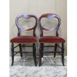 A set of six Victorian balloon back dining chairs with serpentine upholstered seats raised on turned