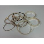 Collection of silver bangles of various design, to include two hinged examples and an example with